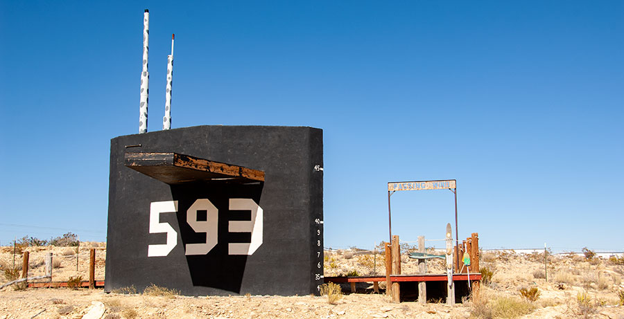 Submarine conning tower in desert.
